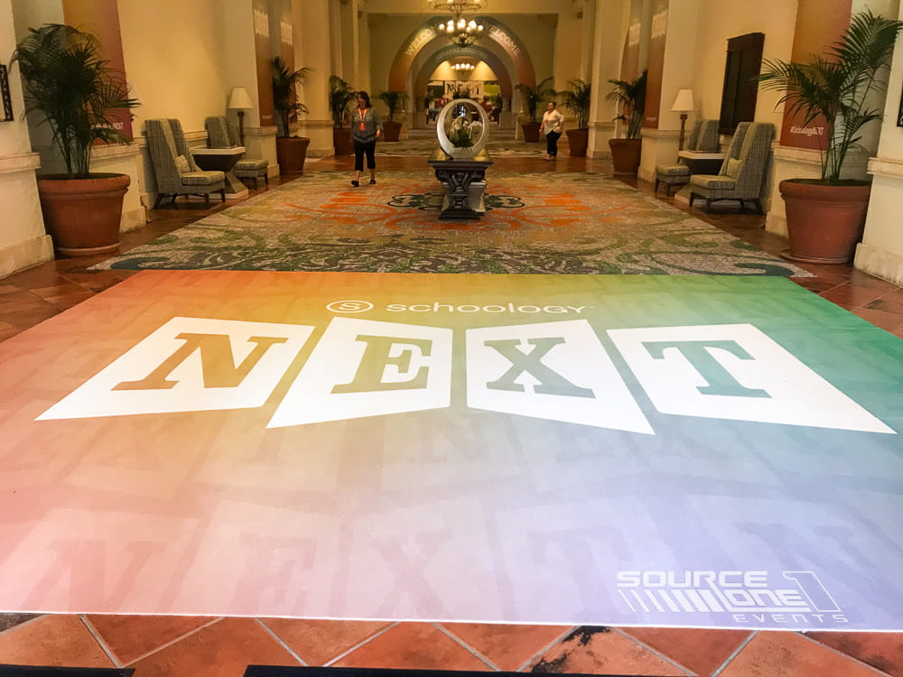 Custom printed carpet creating a branded attendee experience at a conference.