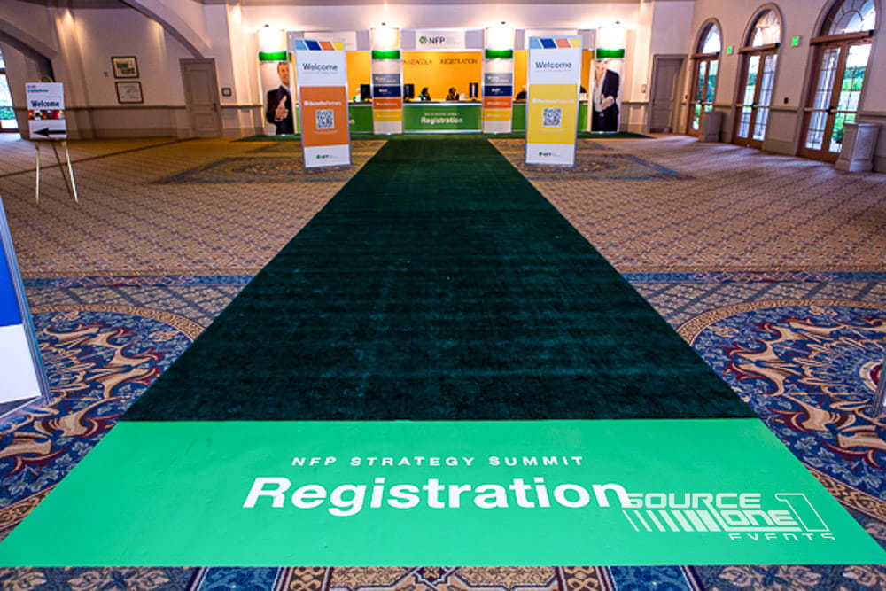 Branded floor clings installed to guide attendees through a conference venue.