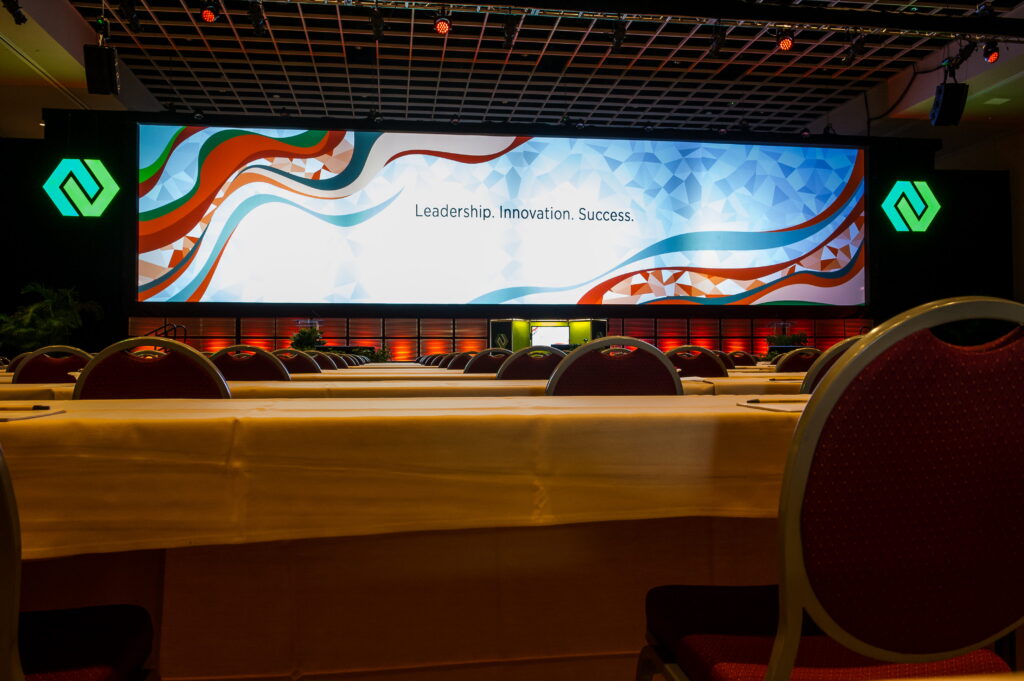 Curved LED display wall creating immersive branded conference environment