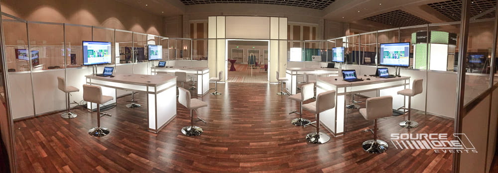Comfortable networking lounge with soft seating, warm lighting, and open gathering space designed for conference attendees.
