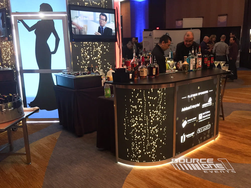 Custom illuminated bar serving attendees during a conference networking event.
