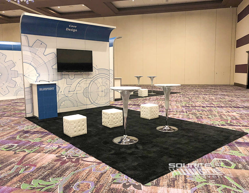 Contemporary financial services exhibit with reception counter, meeting lounge, digital displays, and clean architectural branding.