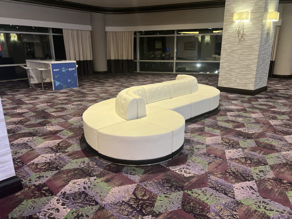 Circular white lounge seating arrangement for convention center networking space