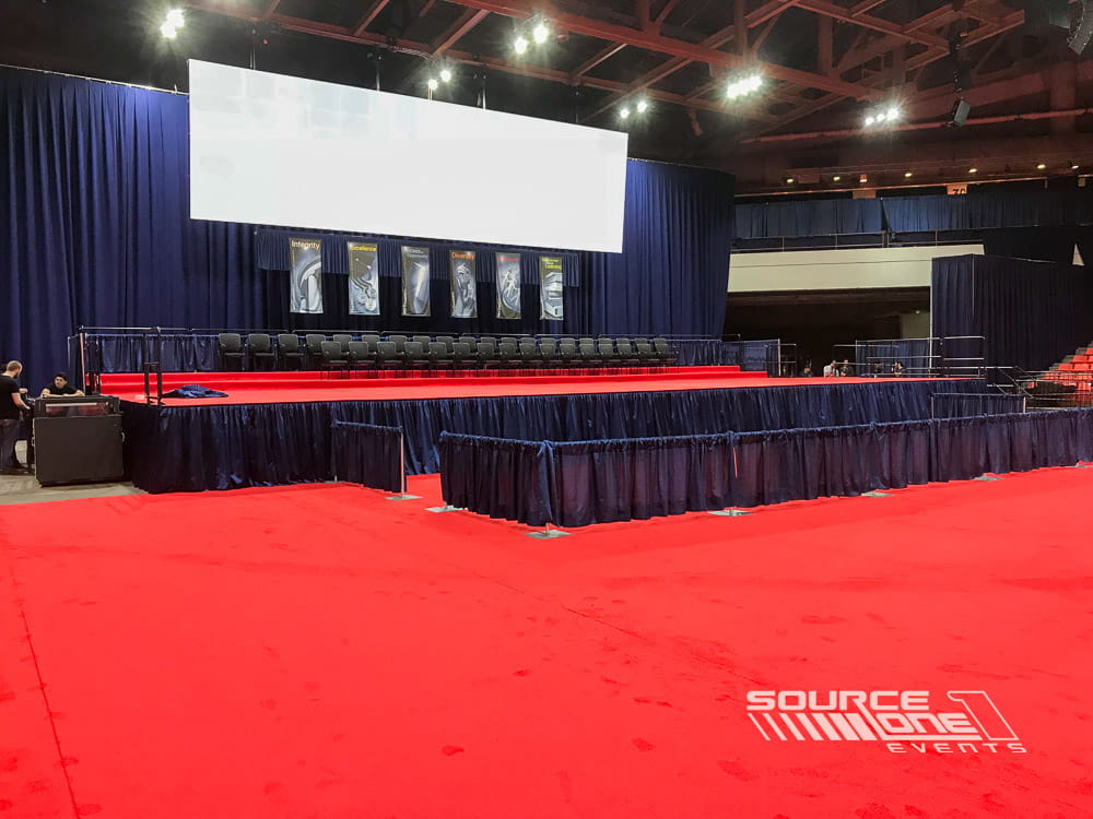 Stage with custom event flooring prepared for a university ceremony.