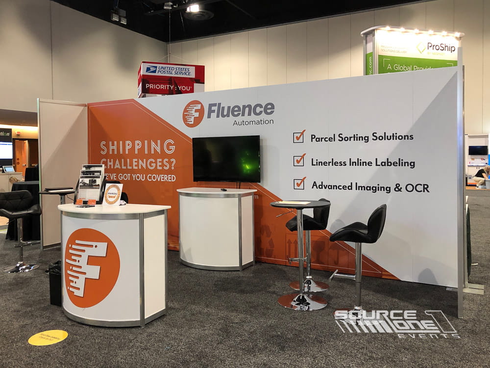 Professional custom exhibit with branded shipping industry graphics, product demonstrations, and interactive exhibitor presentation areas.