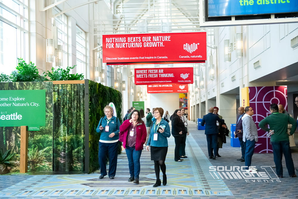 Oversized hanging event graphics identifying the Grand Hall entrance with bold conference branding and wayfinding.