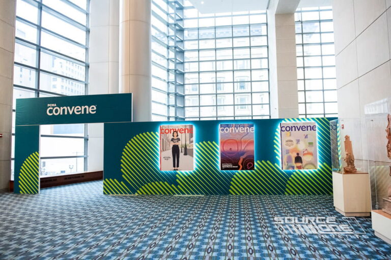 Custom Convene Club lounge featuring branded environmental graphics and networking space inside the convention center.