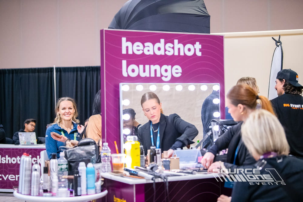 Branded headshot lounge where conference attendees receive complimentary professional portraits.