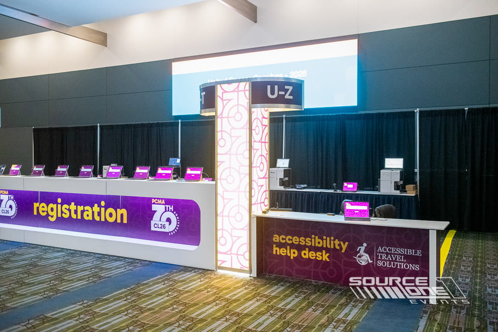 Modern registration experience featuring branded counters, vibrant digital graphics, and attendee check-in stations at PCMA Convening Leaders.