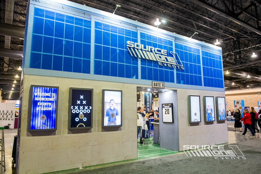 Source One Events branded exhibitor booth featuring large-format graphics, custom exhibit fabrication, and exhibitor service messaging.