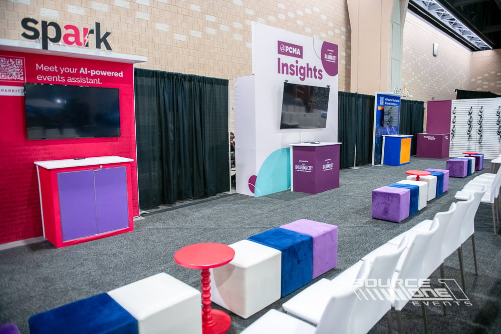 Custom Spark activation booth featuring colorful branded graphics, digital displays, and attendee engagement space designed by Source One Events.