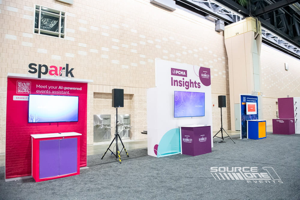 Vibrant custom exhibit featuring bold pink graphics, interactive displays, and experiential branding elements.