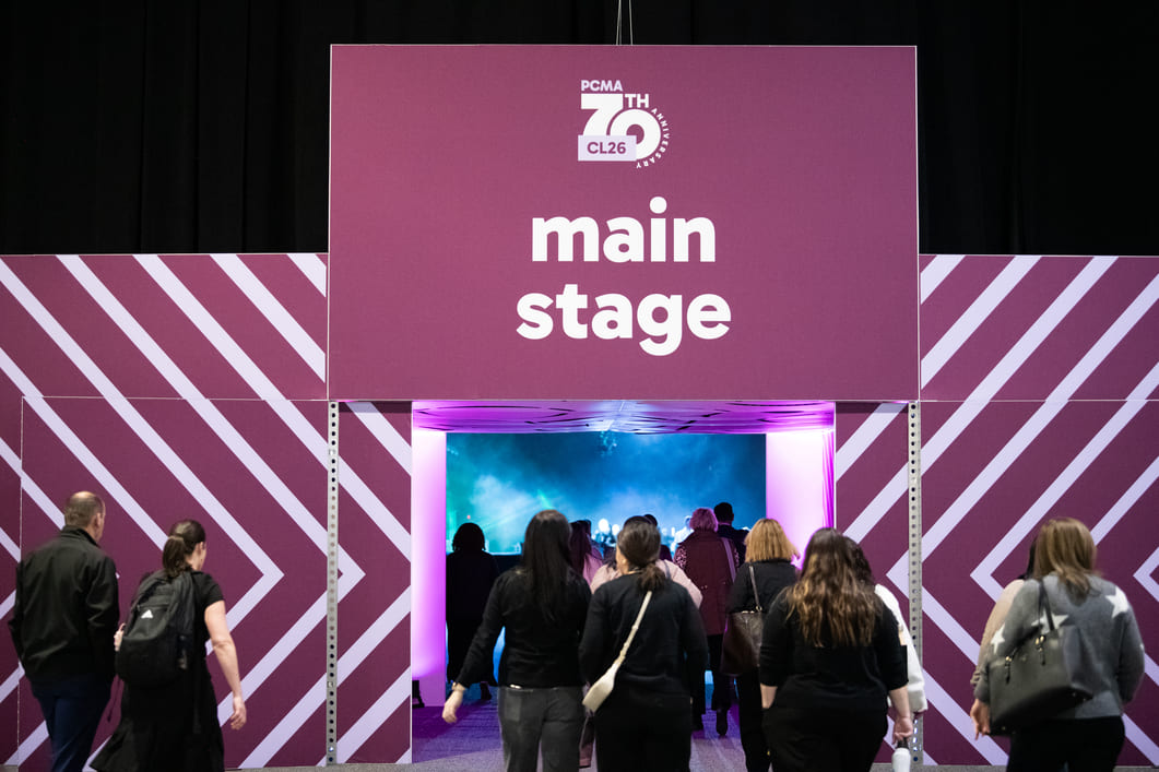Branded entrance leading attendees to the conference main stage with custom event graphics.