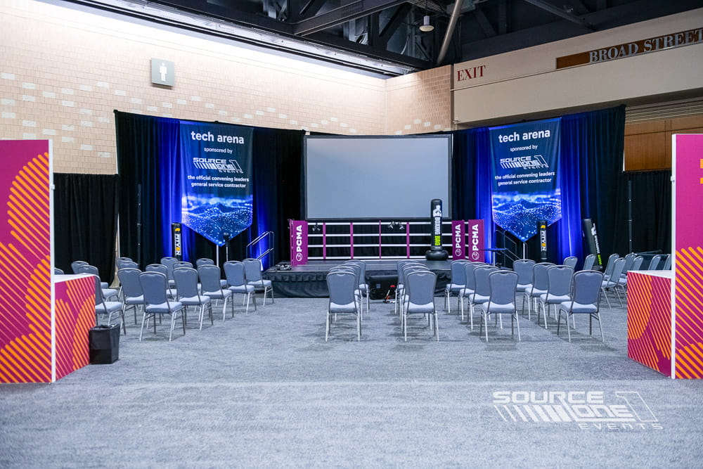 Branded technology pavilion featuring colorful environmental graphics and interactive conference programming.