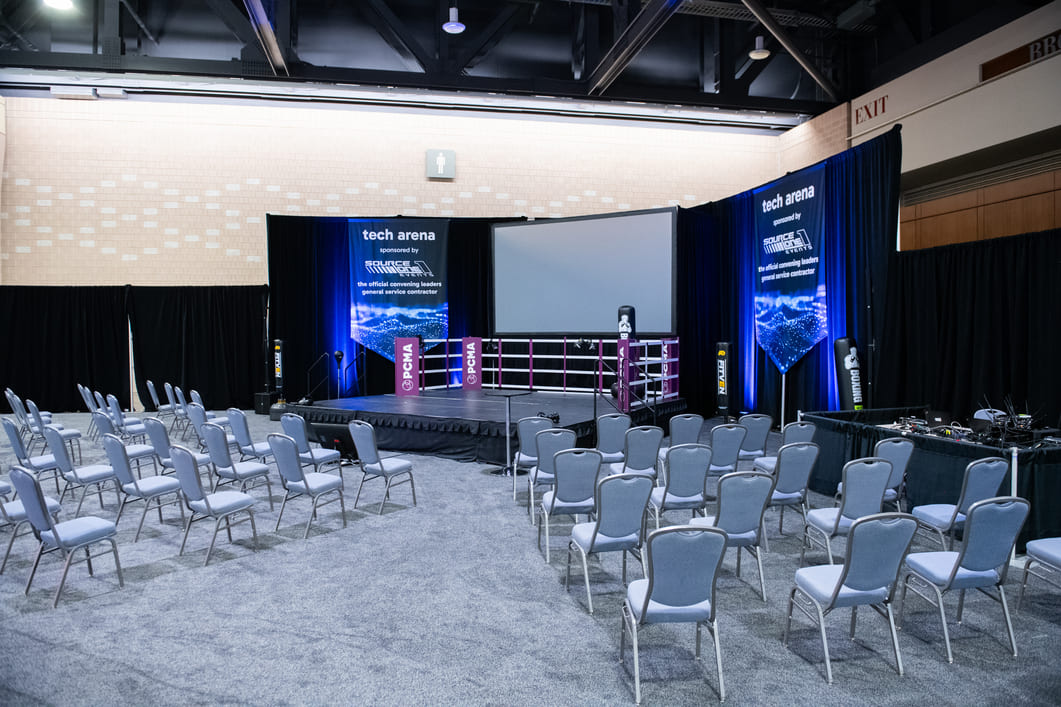Technology presentation stage prepared for conference sessions inside a convention center.
