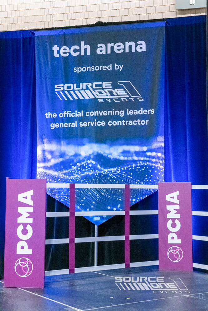 Large suspended directional banners promoting event messaging and improving navigation throughout the convention center.