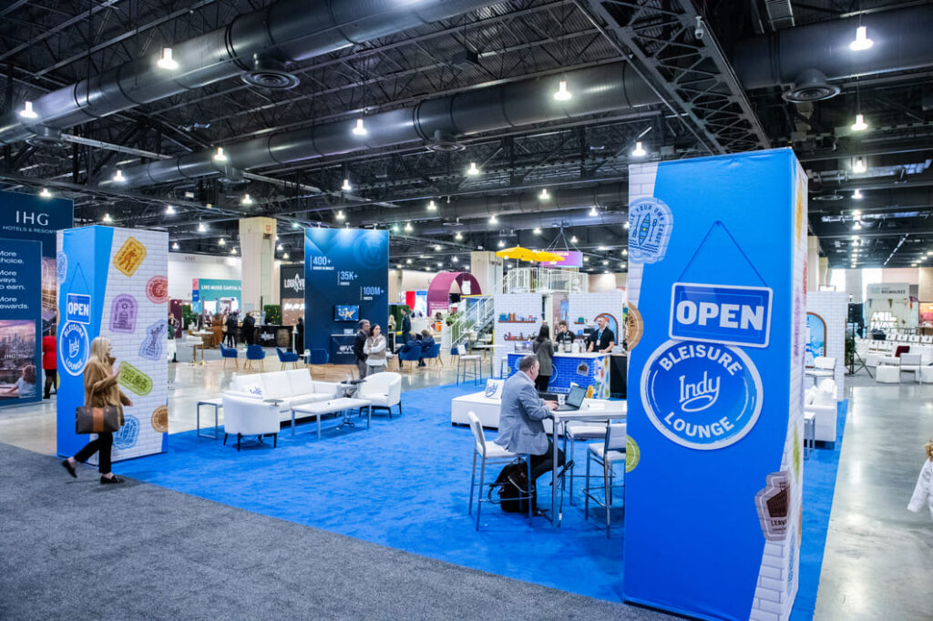 Custom Visit Indy exhibit booth featuring branded displays and interactive experiences on the conference show floor.