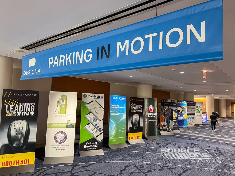 Branded ceiling-mounted banners guiding attendees through the conference venue with consistent event branding.