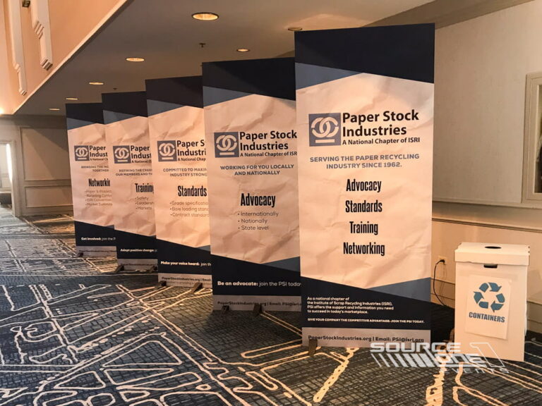 Branded wayfinding displays helping attendees navigate the conference venue.