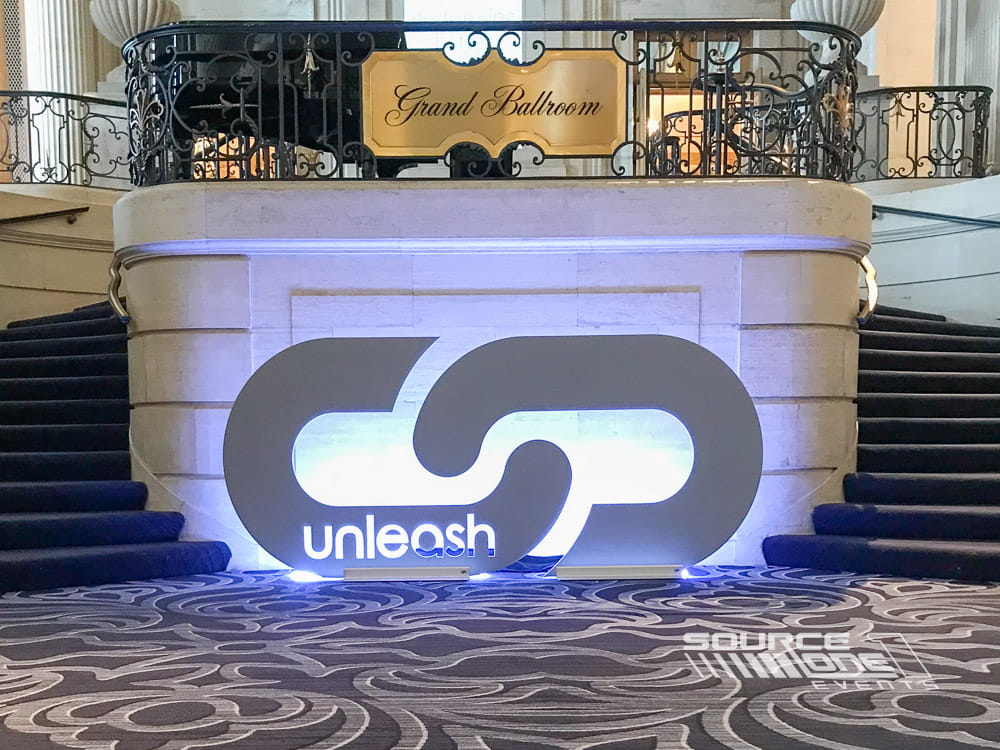 Illuminated three-dimensional Performance Health logo displayed inside the event venue.