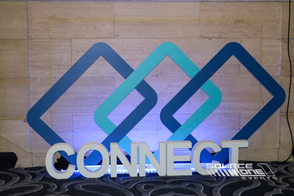 Freestanding three-dimensional Performance Health logo used as event branding.
