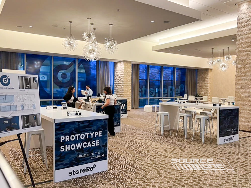 Elegant networking area with round tables, banquet lighting, and comfortable meeting space within the conference venue.