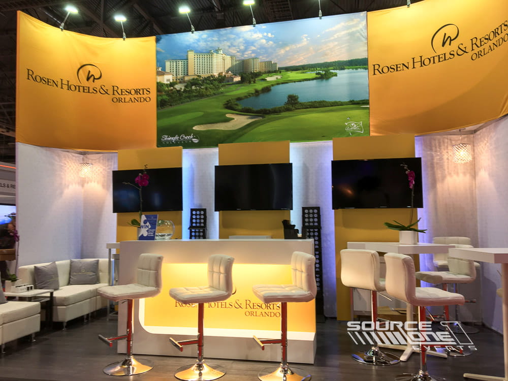 Custom exhibit highlighting hospitality branding with large-format graphics and welcoming meeting areas.