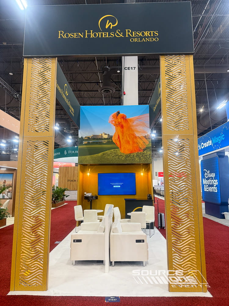 Premium hospitality exhibit featuring elegant architectural design, illuminated graphics, and visitor meeting spaces.