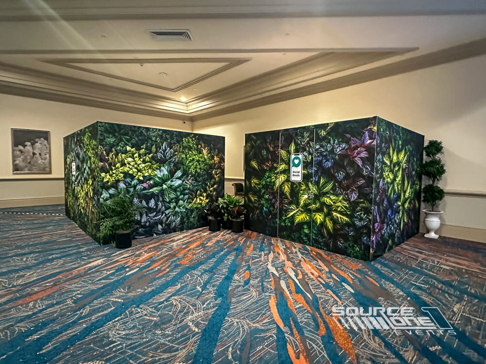 Large custom-built conference rooms featuring immersive botanical wall graphics, premium hard-wall construction, and branded meeting environments.