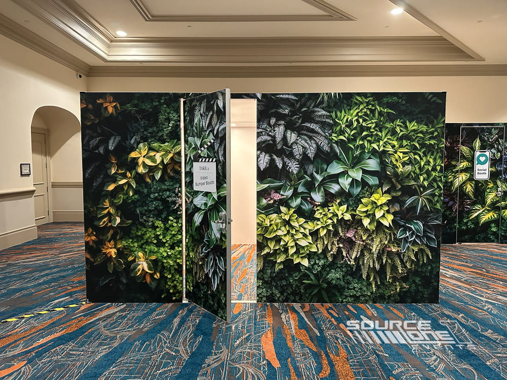 Fully enclosed podcast recording studio with custom environmental graphics, acoustic walls, and professional event content production space.