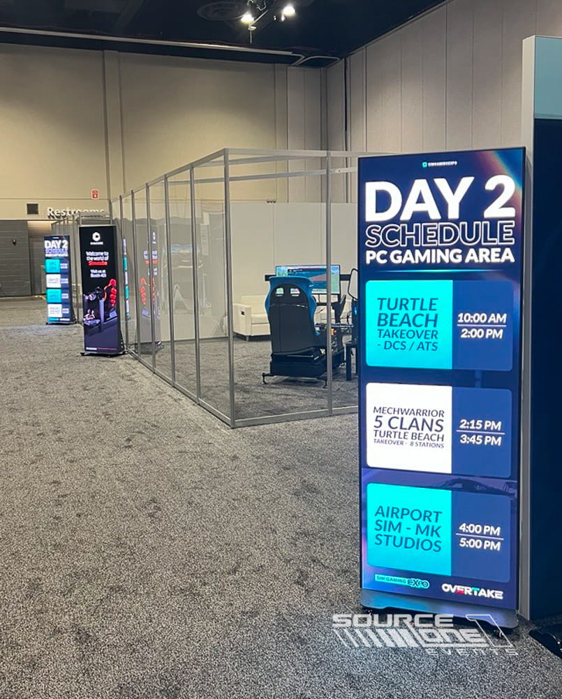 Digital LED gaming information display with branded event graphics directing attendees to competitive gaming experiences.
