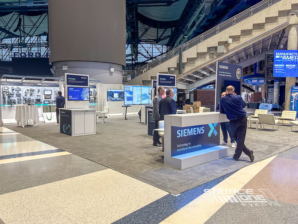 Large custom Siemens Energy exhibit featuring premium architecture, meeting spaces, and branded environmental graphics.
