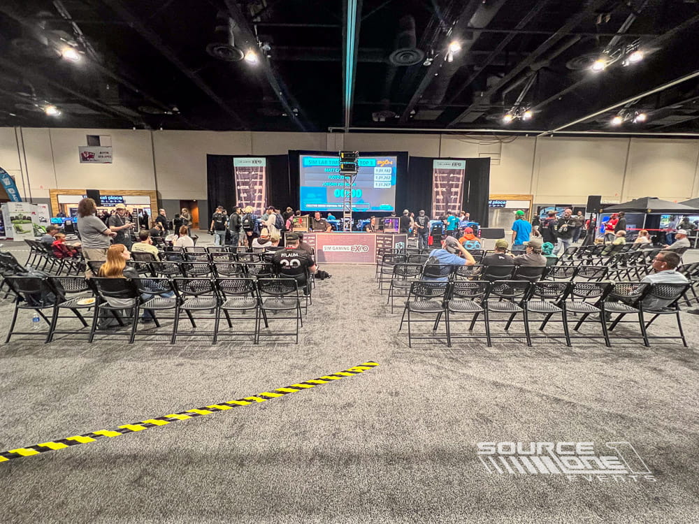 Esports competition stage featuring large LED screens, audience seating, and live tournament production.