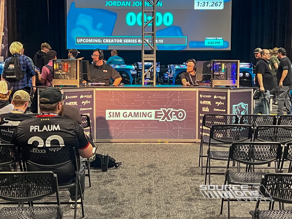 Esports competition stage with large digital displays and audience seating at Sim Gaming Expo 2025.