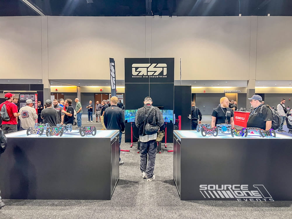 Custom exhibit booth for Gomez at Sim Gaming Expo featuring branded graphics and attendee meeting space.