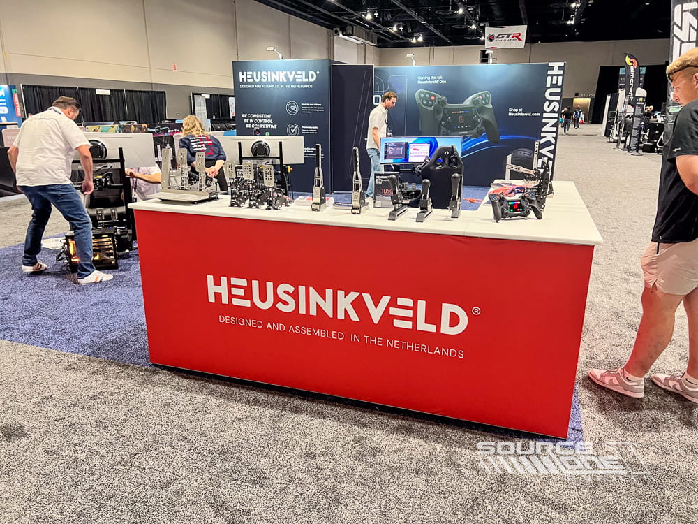 Heusinkveld exhibit booth showcasing racing simulation products and branded displays at Sim Gaming Expo.