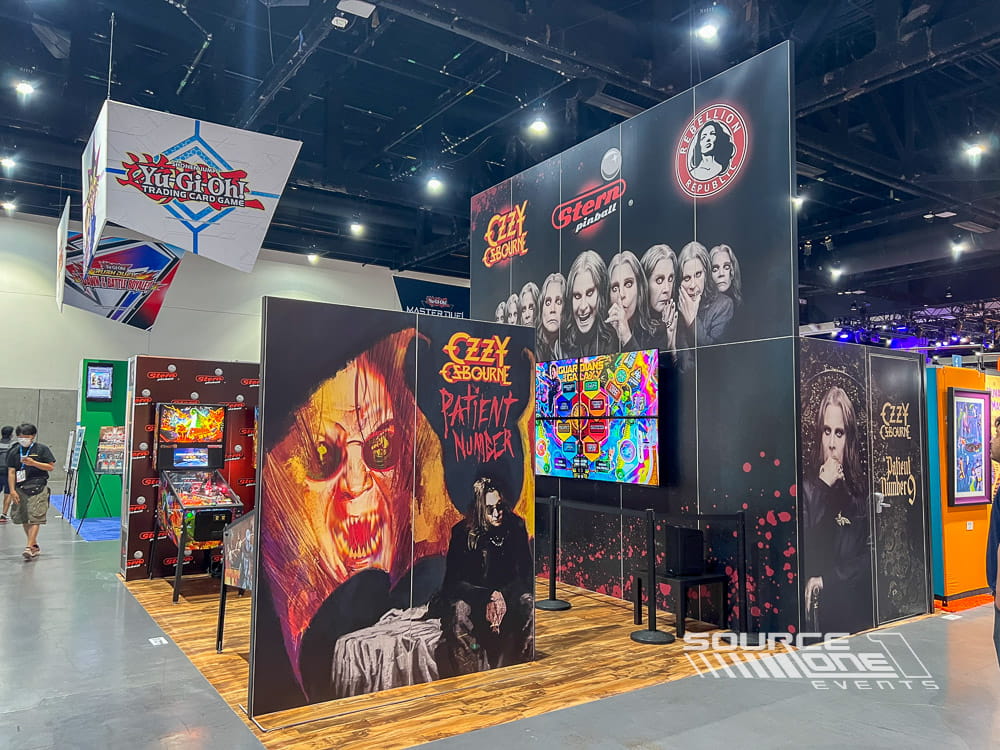 Expansive branded exhibit with illuminated displays, themed graphics, and attendee interaction zones.