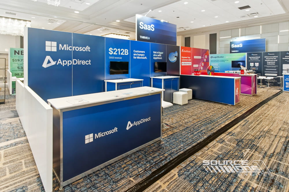Large custom booth with multiple product stations, branded graphics, integrated technology, and open visitor pathways.