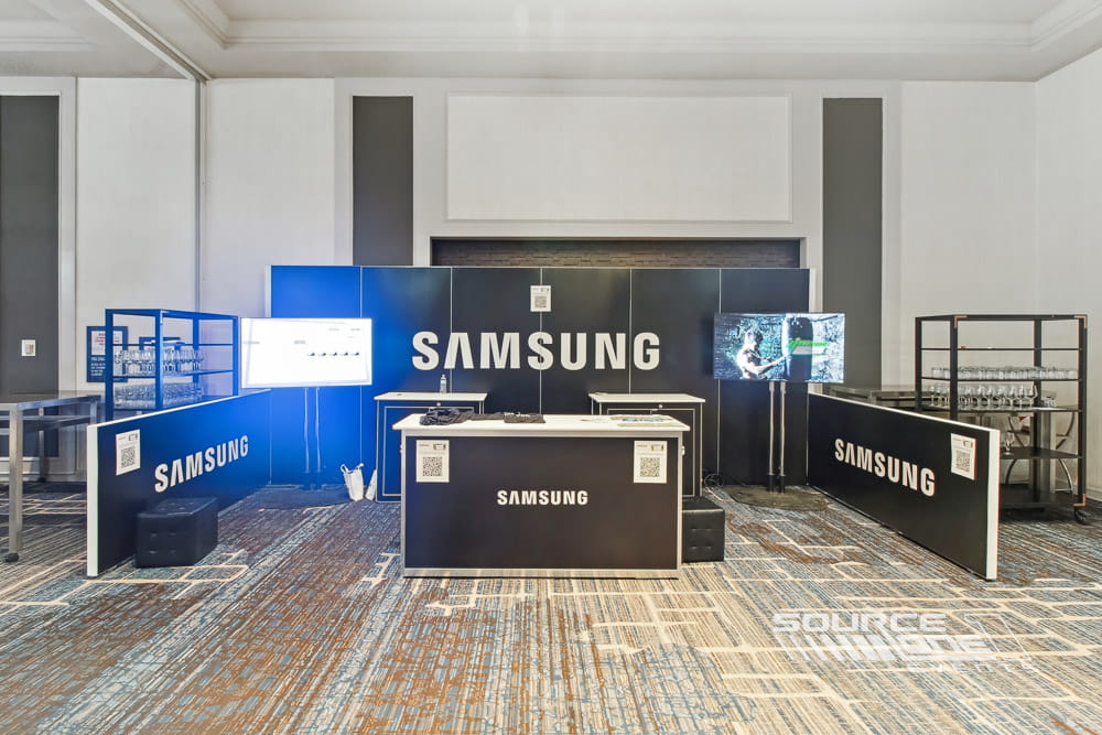 Samsung technology display integrated into a custom hardwall exhibit with modern branding and digital signage.
