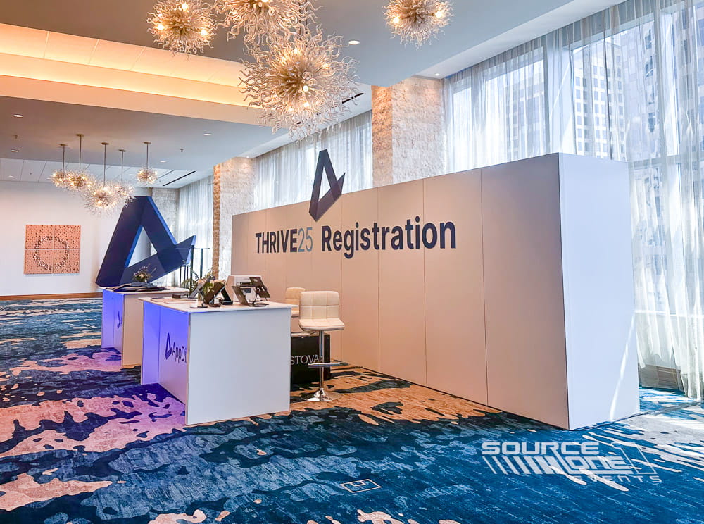 Large custom THRIVE logo displayed at the conference registration area.
