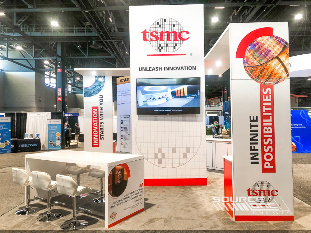 Open-concept exhibit booth showcasing product demonstrations, digital media, and premium architectural finishes.