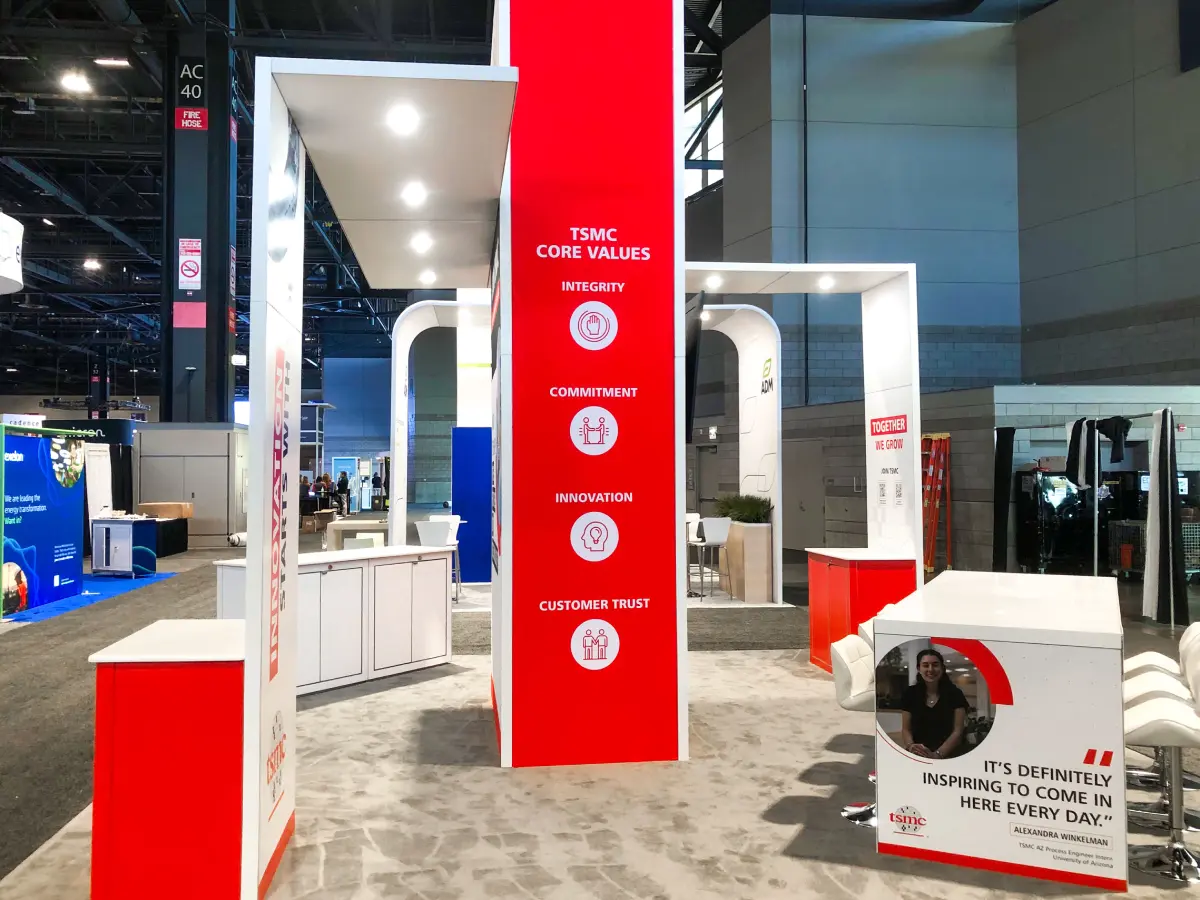 Double-height trade show exhibit tower with integrated branding and messaging