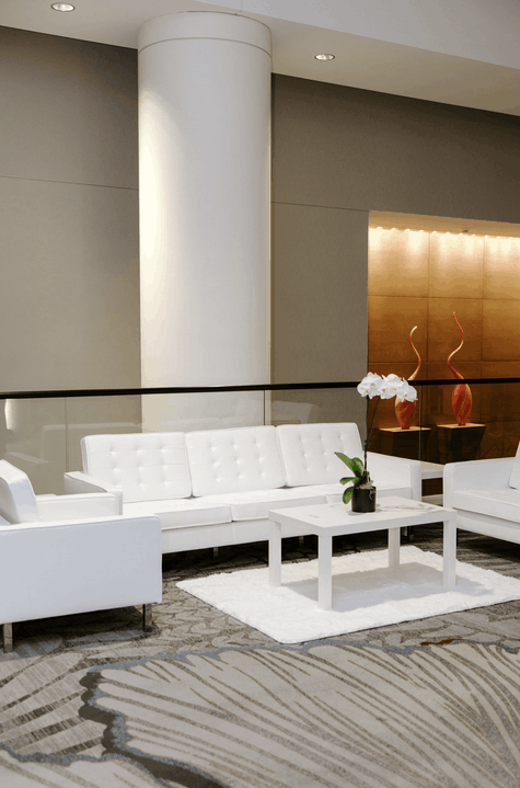 White leather sofa rental for corporate event lounge and networking areas