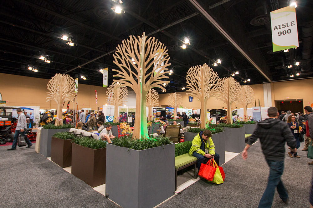 Immersive trade show activation featuring decorative illuminated tree installation