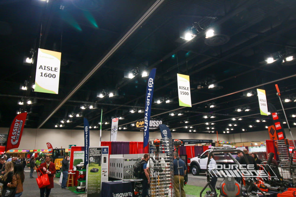 Multiple suspended aisle signs installed throughout the trade show floor improving exhibitor visibility and attendee navigation.