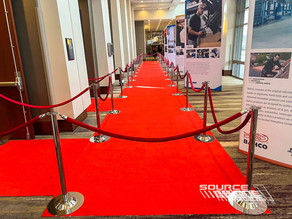Red carpet entrance with stanchions creating a formal arrival experience for event attendees.