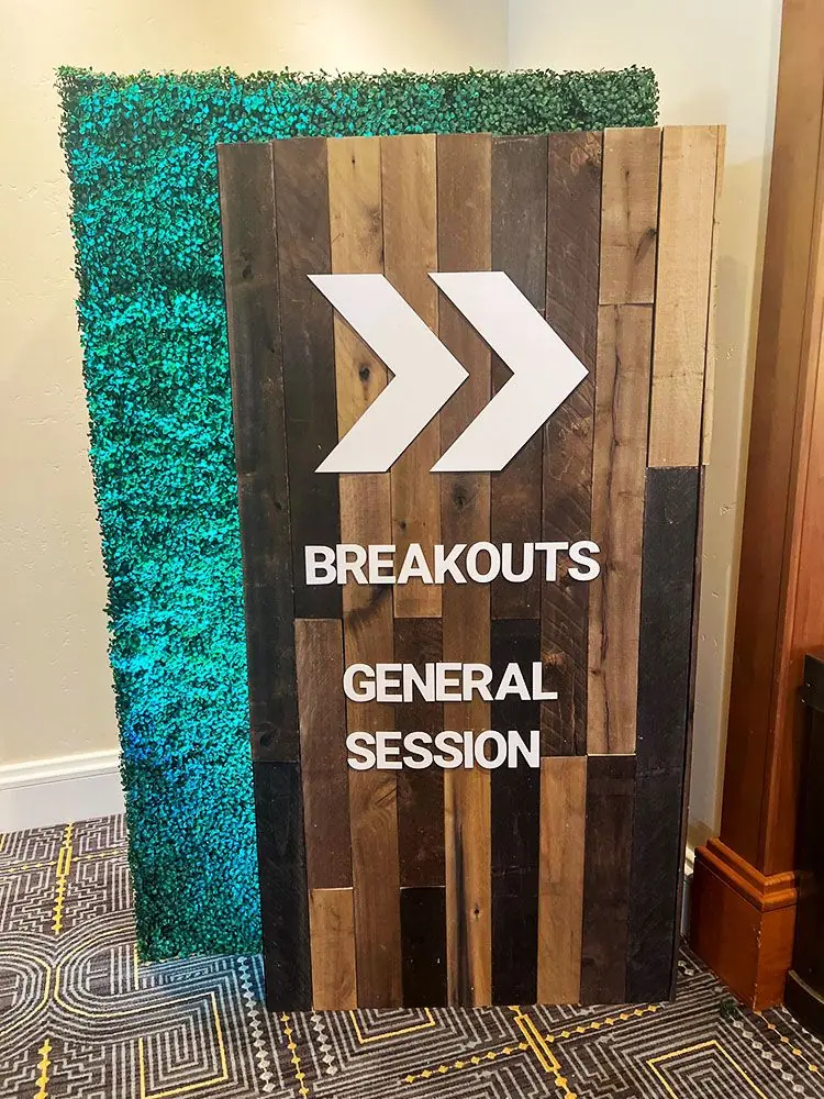 Wayfinding sign directing attendees to breakout sessions and general conference programming.
